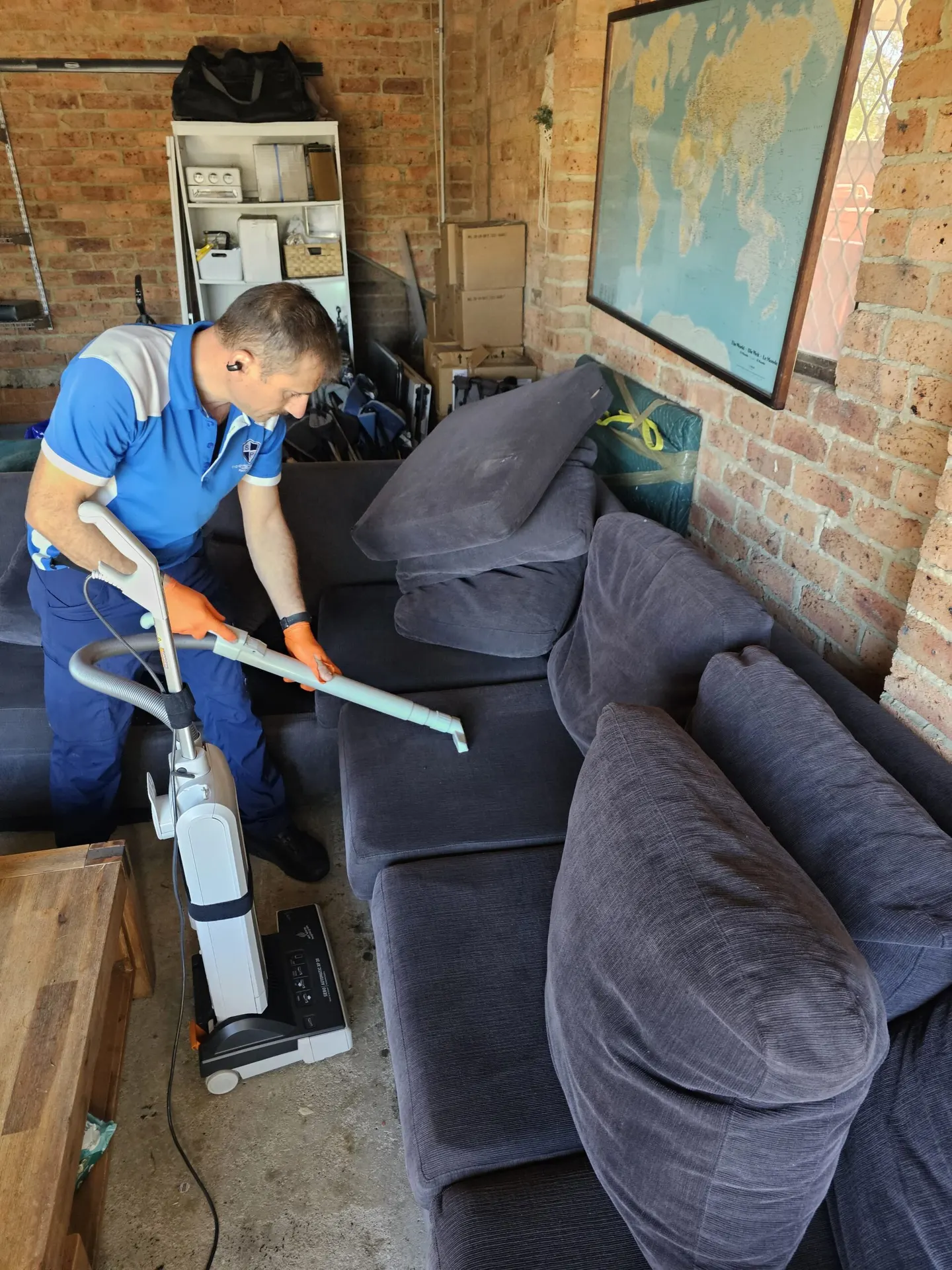 Sydney Pesties technician treating a living room sofa for fleas